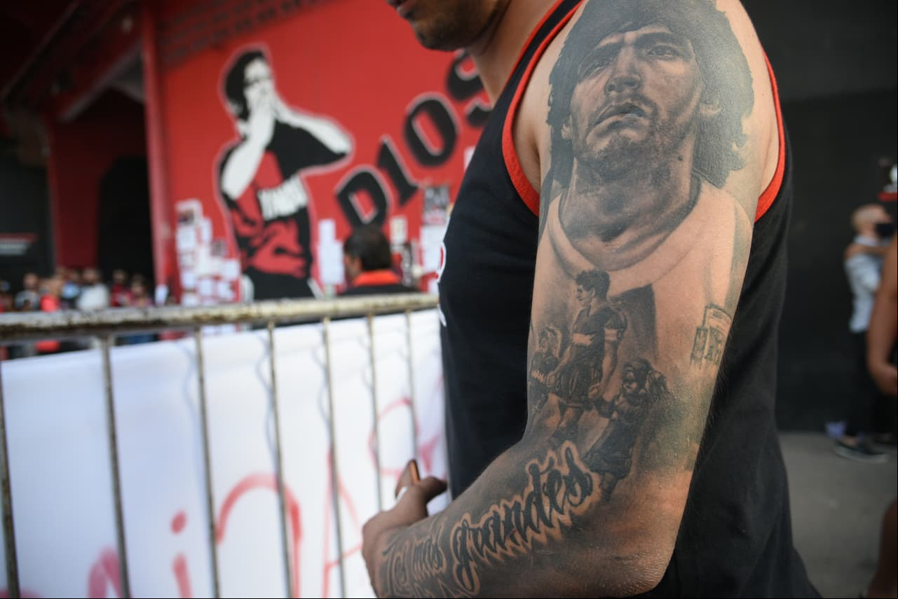 En Rosario, un fanático con el rostro de Maradona tatuado en su brazo izquierdo se acerca al Estadio Marcelo Bielsa para rendirle homenaje a su ídolo.